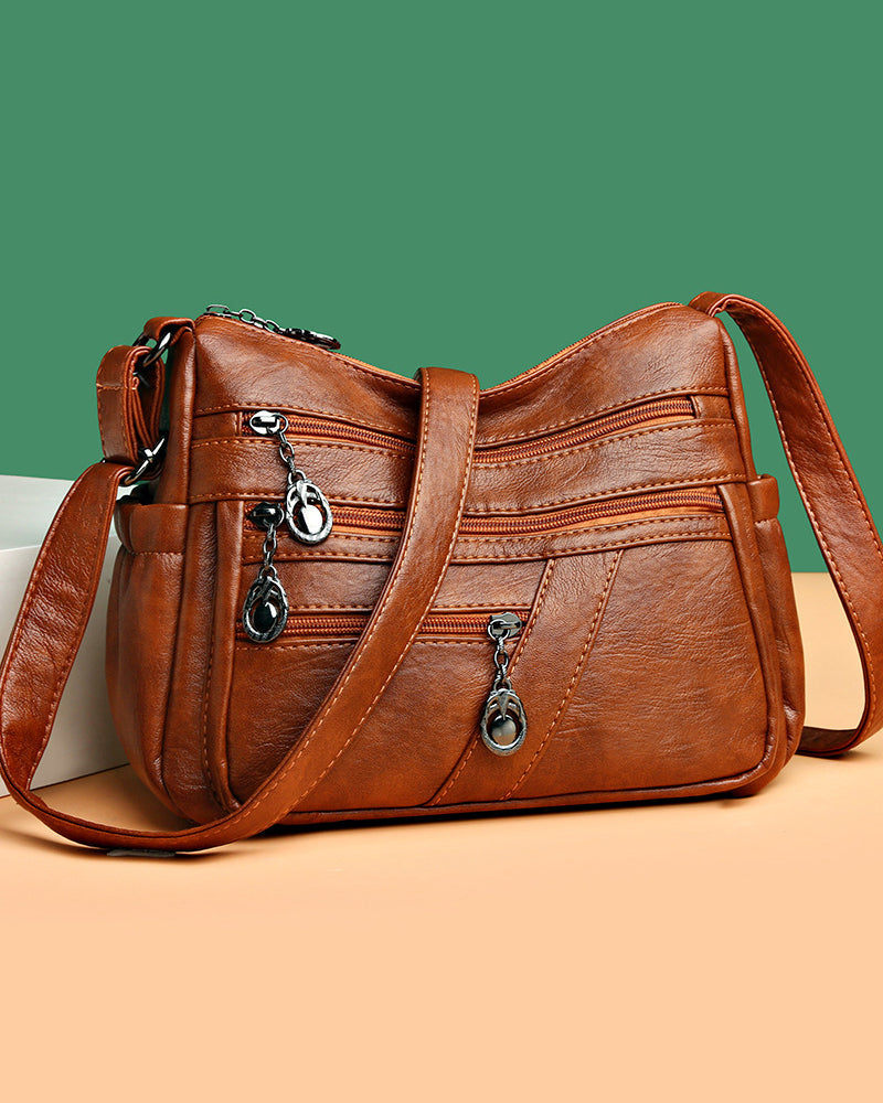 Bolso bandolera de cuero suave con múltiples bolsillos