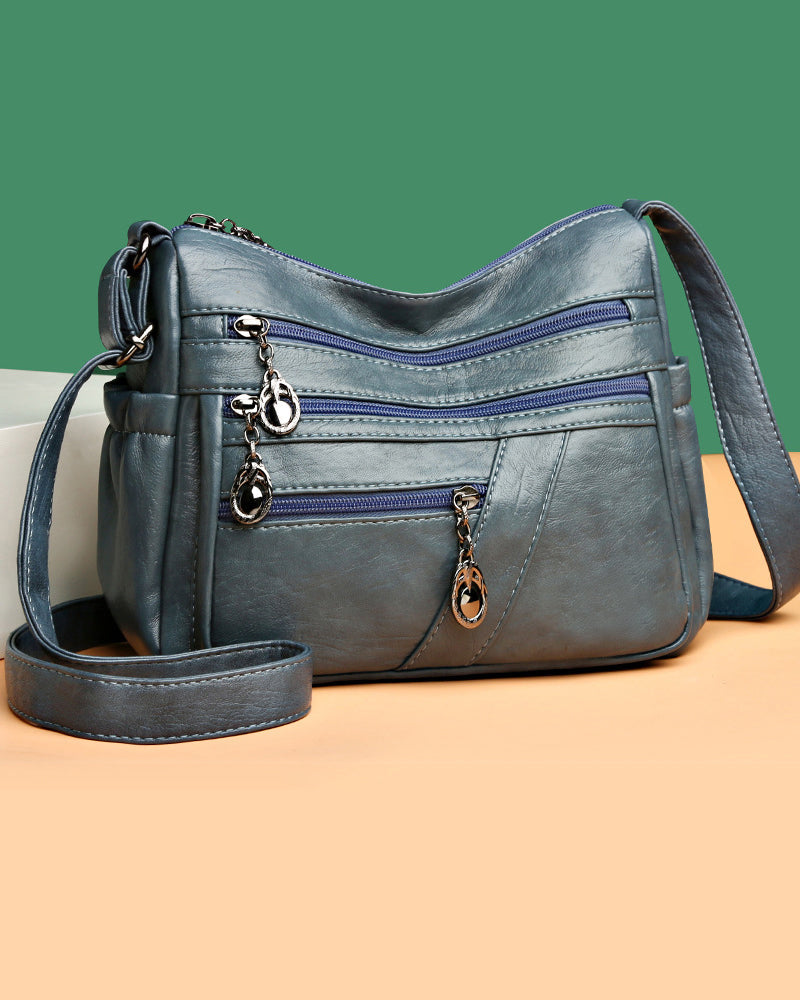 Bolso bandolera de cuero suave con múltiples bolsillos