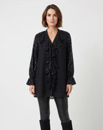 Blusa amplia lisa con volantes