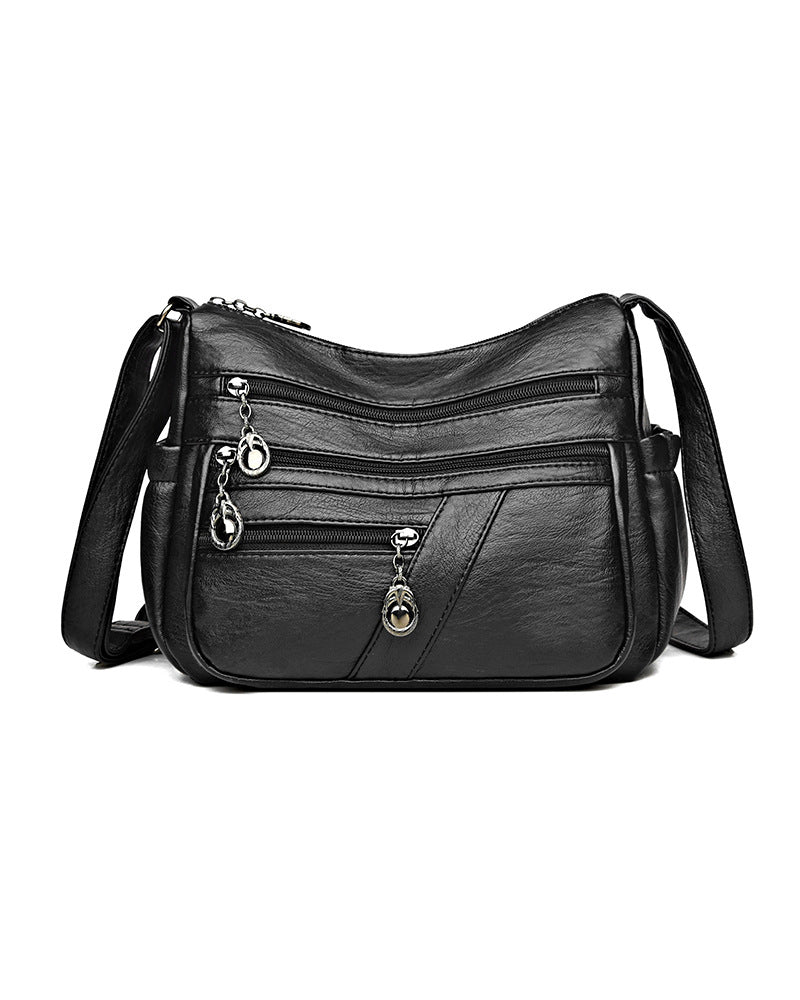 Bolso bandolera de cuero suave con múltiples bolsillos