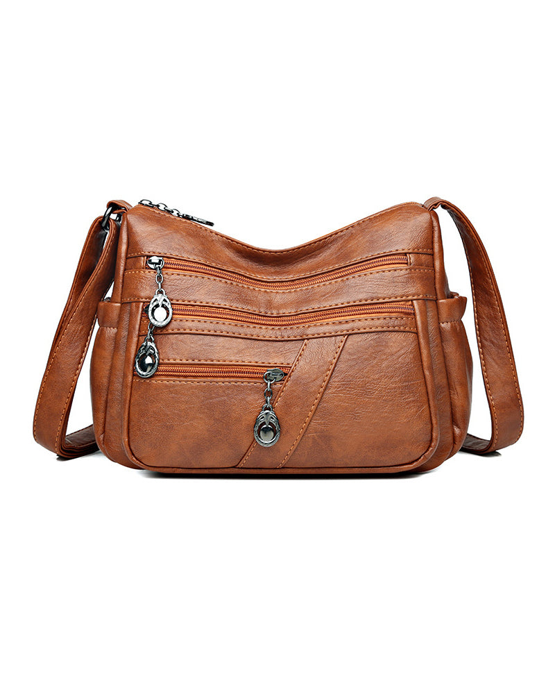 Bolso bandolera de cuero suave con múltiples bolsillos