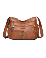 Bolso bandolera de cuero suave con múltiples bolsillos