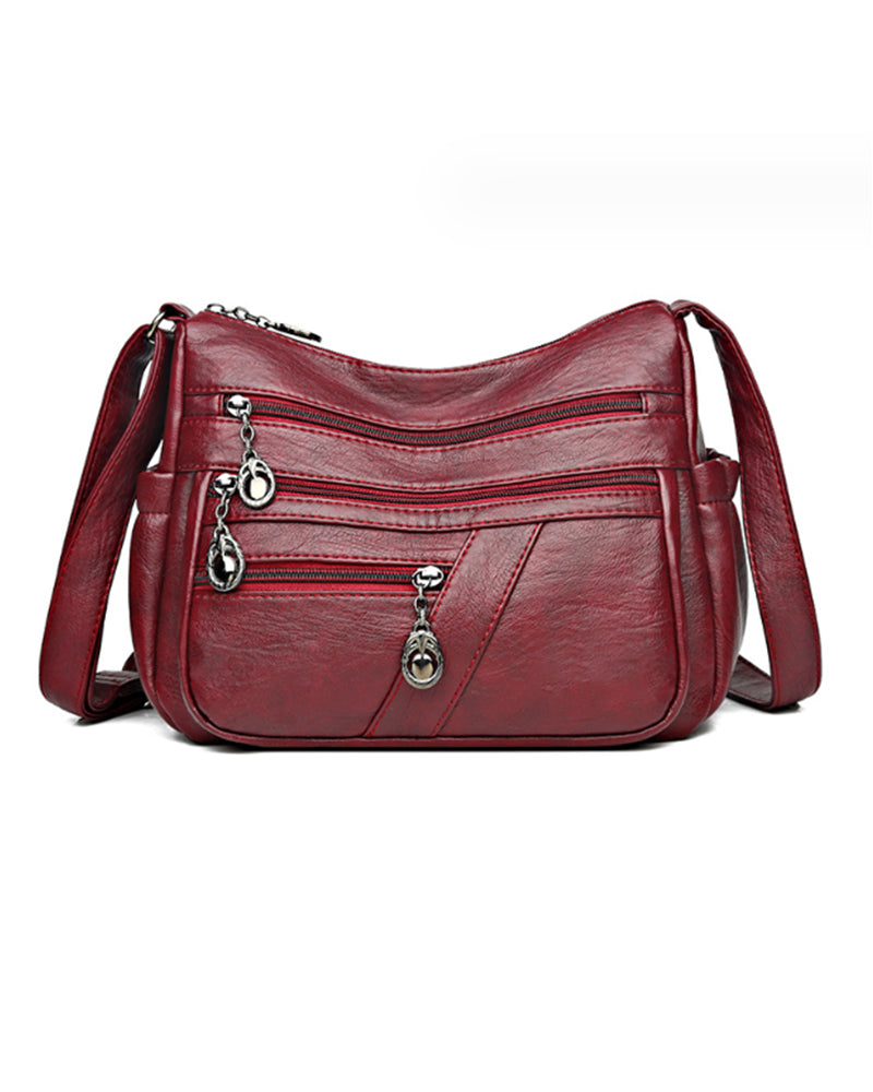 Bolso bandolera de cuero suave con múltiples bolsillos
